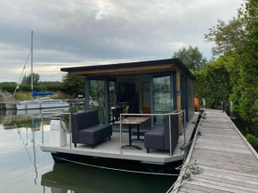Modern house boat in Monnickendam with jetty